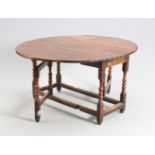 AN 18TH CENTURY RED WALNUT GATELEG TABLE