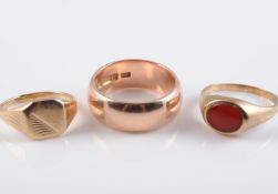 A 9 CARAT GOLD WEDDING BAND AND TWO 9 CARAT GOLD SIGNET RINGS