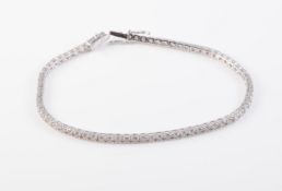 AN 18CT WHITE GOLD AND DIAMOND LINE BRACELET