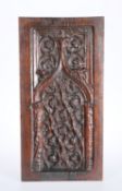 A CARVED OAK PANEL DECORATED IN RELIEF WITH GOTHIC TRACERY