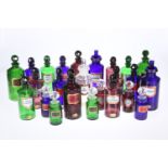 A LARGE COLLECTION OF COLOURED AND CLEAR GLASS PERIOD STYLE PHARMACEUTICAL JARS AND AND MEASURES