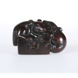 A JAPANESE CARVED WOODEN NETSUKE