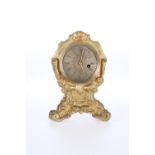 A SMALL GILT-METAL CLOCK WITH VERGE WATCH MOVEMENT