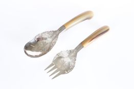 A PAIR OF SILVER AND HORN HANDLED SALAD SERVERS