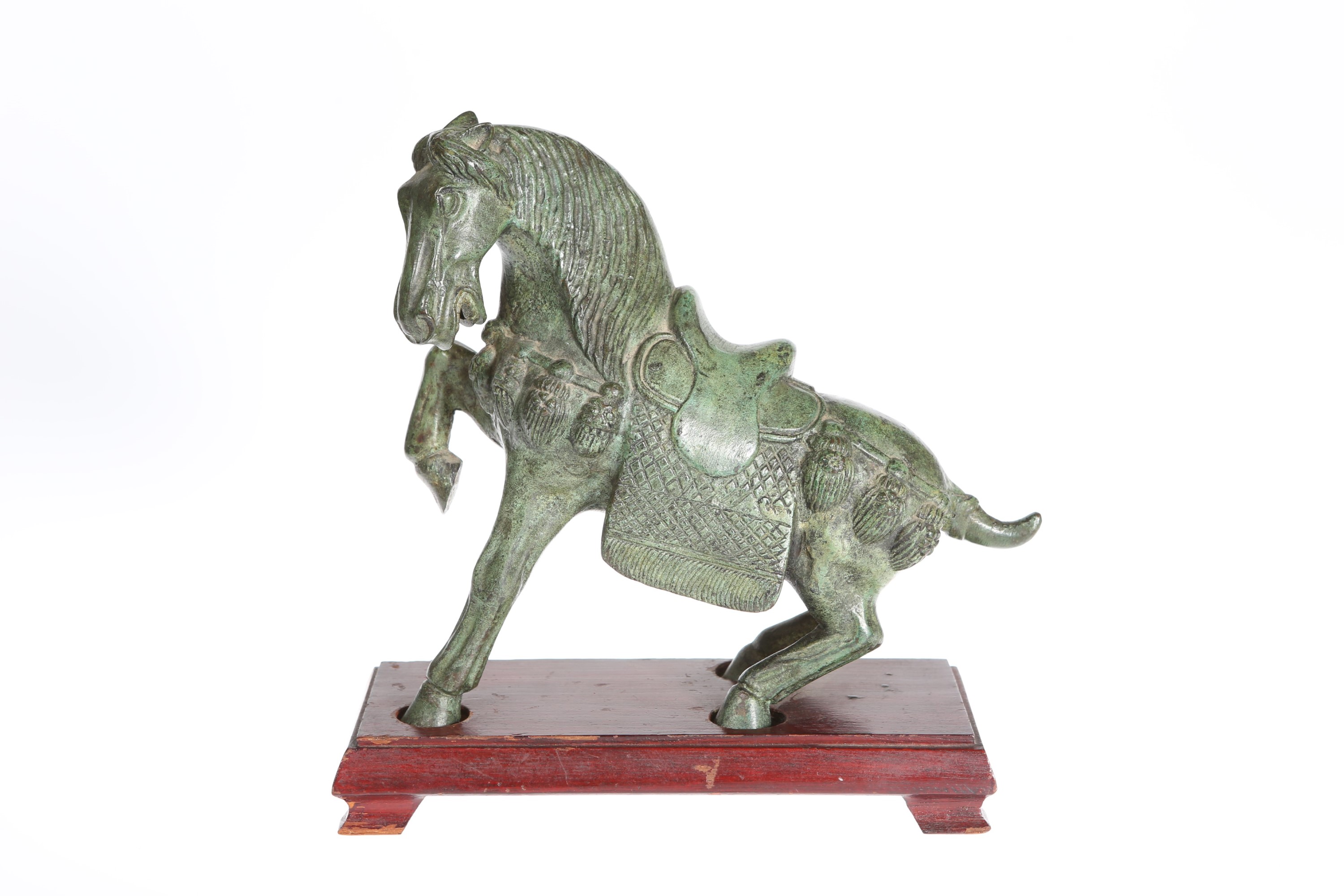 A CHINESE PATINATED BRONZE OF A HORSE, IN TANG STYLE