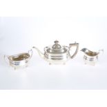 AN EDWARDIAN THREE PIECE SILVER TEA SERVICE, C.S. HARRIS & SONS LTD, LONDON 1909 AND 1910