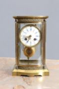 A LATE 19th CENTURY FRENCH BRASS FOUR-GLASS MANTEL CLOCK