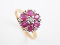 AN 18CT YELLOW GOLD RUBY AND DIAMOND CLUSTER RING