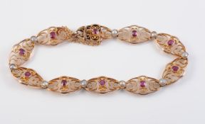 A 9CT YELLOW GOLD, RUBY AND SEED PEARL BRACELET