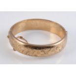 A 9 CARAT GOLD HINGED BANGLE