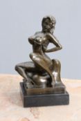 AN EROTIC BRONZE FIGURE OF A SEATED FEMALE STRIPPER 20TH CENTURY