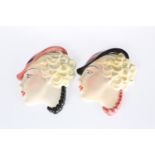 A PAIR OF FEMALE MASK WALL APPLIQUES IN THE ART DECO TASTE