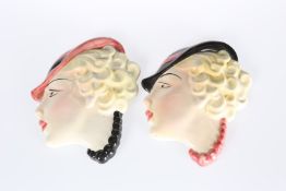 A PAIR OF FEMALE MASK WALL APPLIQUES IN THE ART DECO TASTE