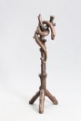 A CARVED OAK "SERPENT" HAT AND COAT STAND