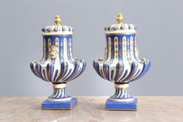A PAIR OF CONTINENTAL PORCELAIN URNS AND COVERS IN THE MANNER OF SEVRES