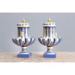 A PAIR OF CONTINENTAL PORCELAIN URNS AND COVERS IN THE MANNER OF SEVRES