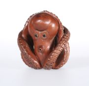 A JAPANESE WOODEN NETSUKE OF AN OCTOPUS