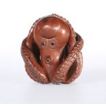 A JAPANESE WOODEN NETSUKE OF AN OCTOPUS