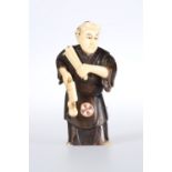 A JAPANESE IVORY AND WOOD FIGURAL NETSUKE