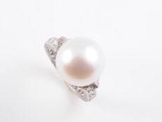 A CULTURED PEARL AND DIAMOND RING BY CARTIER