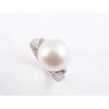 A CULTURED PEARL AND DIAMOND RING BY CARTIER