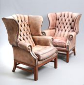 A HANDSOME PAIR OF LEATHER WING CHAIRS IN GEORGE III STYLE