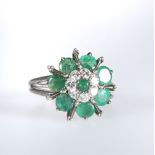 AN EMERALD AND DIAMOND CLUSTER RING