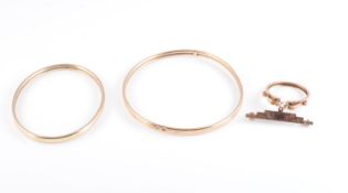 TWO 9 CARAT GOLD BANGLES AND A 9 CARAT GOLD SOVEREIGN MOUNT