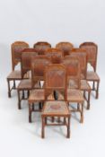 A SET OF TEN MOORISH STYLE STAMPED LEATHER AND OAK DINING CHAIRS