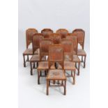 A SET OF TEN MOORISH STYLE STAMPED LEATHER AND OAK DINING CHAIRS