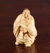 A JAPANESE IVORY NETSUKE OF A SAMURAI