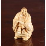 A JAPANESE IVORY NETSUKE OF A SAMURAI