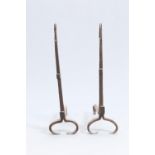 A PAIR OF ARTS AND CRAFTS WROUGHT IRON GOOSENECK ANDIRONS