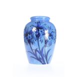 WILLIAM MOORCROFT, A CORNFLOWER PATTERN POWDER BLUE VASE, CIRCA 1925