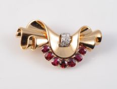 A RUBY AND DIAMOND SET BROOCH IN THE MANNER OF VAN CLEEF AND ARPELS