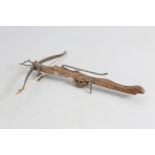 A CARVED OAK AND IRON STONE CROSSBOW