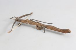 A CARVED OAK AND IRON STONE CROSSBOW