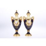 A PAIR OF COALPORT TWO-HANDLED PORCELAIN VASES AND COVERS