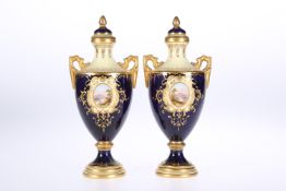 A PAIR OF COALPORT TWO-HANDLED PORCELAIN VASES AND COVERS