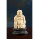 A 19TH CENTURY CHINESE CARVED IVORY BUDDHA