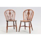 A PAIR OF EARLY 19TH CENTURY YEW AND ELM WHEELBACK WINDSOR CHAIRS