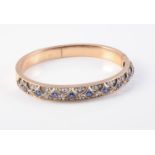 A LATE 19TH CENTURY SAPPHIRE AND DIAMOND BANGLE