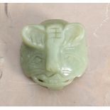 A CHINESE CARVED GREEN HARDSTONE BUCKLE