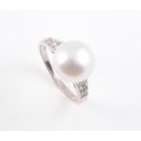 A CULTURED PEARL AND DIAMOND SET RING