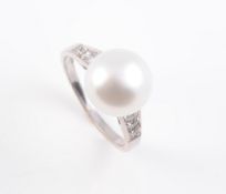 A CULTURED PEARL AND DIAMOND SET RING