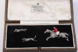 A LATE 19TH CENTURY HUNTSMAN, HOUND AND FOX BROOCH