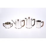 A VINTAGE ENGLISH WHITE METAL FOUR PIECE TEA AND COFFEE SERVICE IN THE ART DECO TASTE