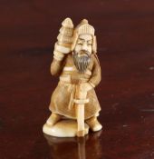 A JAPANESE IVORY NETSUKE OF A SAMURAI