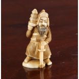 A JAPANESE IVORY NETSUKE OF A SAMURAI