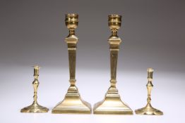 TWO PAIRS OF BRASS CANDLESTICKS